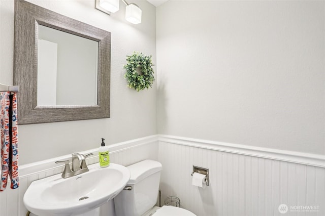 6413 152nd Ave E, Sumner, WA 98390 - bathroom with a sink, a wainscoted wall, and toilet