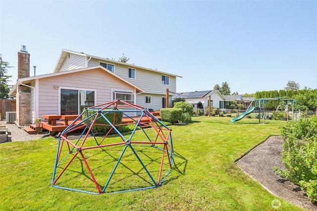 6413 152nd Ave E, Sumner, WA 98390 - back of house featuring a playground, a chimney, and central air condition unit