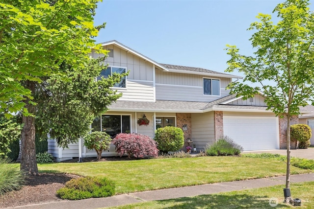 6413 152nd Ave E, Sumner, WA 98390 - view of front of house featuring an attached garage, concrete driveway, a front yard, a shingled roof, and brick siding