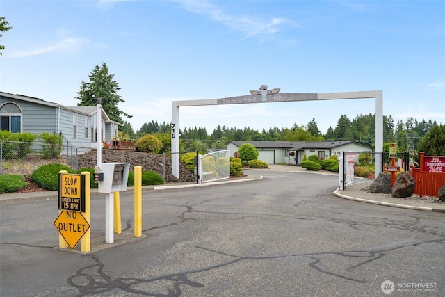 716 Dennis St SE Unit 93, Tumwater, WA 98501 - view of asphalt street with a gated entry and curbs