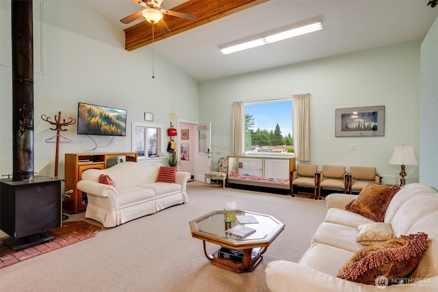 716 Dennis St SE Unit 93, Tumwater, WA 98501 - living room with carpet, a wood stove, beam ceiling, high vaulted ceiling, and a ceiling fan