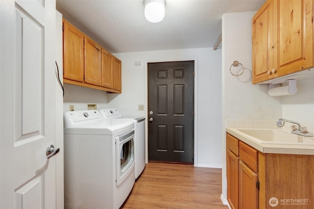 716 Dennis St SE Unit 93, Tumwater, WA 98501 - washroom with washer and clothes dryer, cabinet space, and light wood finished floors