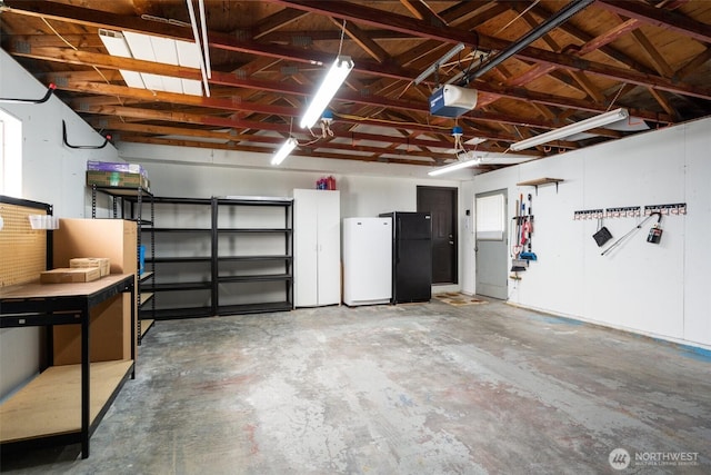 716 Dennis St SE Unit 93, Tumwater, WA 98501 - garage with freestanding refrigerator and a garage door opener