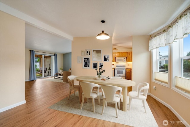 716 Dennis St SE Unit 93, Tumwater, WA 98501 - dining area with light wood-style flooring and beamed ceiling