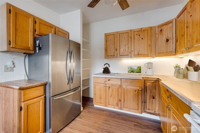 716 Dennis St SE Unit 93, Tumwater, WA 98501 - kitchen featuring freestanding refrigerator, light wood-type flooring, light countertops, a ceiling fan, and stove