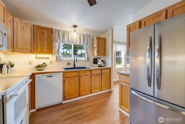 716 Dennis St SE Unit 93, Tumwater, WA 98501 - kitchen featuring white appliances, light wood-style flooring, and light countertops