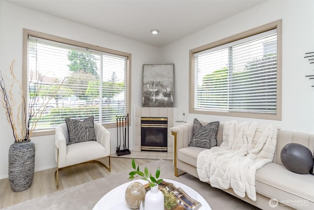 5129 Green Hills Ave NE Unit A, Tacoma, WA 98422 - living room featuring plenty of natural light, a tiled fireplace, wood finished floors, and baseboards