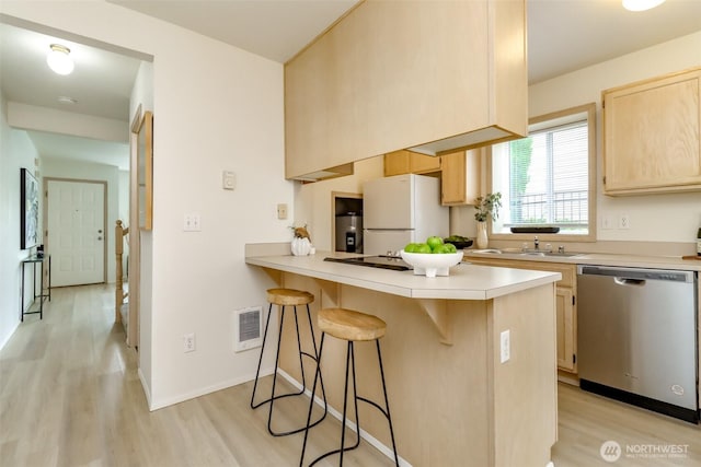 5129 Green Hills Ave NE Unit A, Tacoma, WA 98422 - kitchen with dishwasher, light brown cabinets, freestanding refrigerator, and light wood-style floors