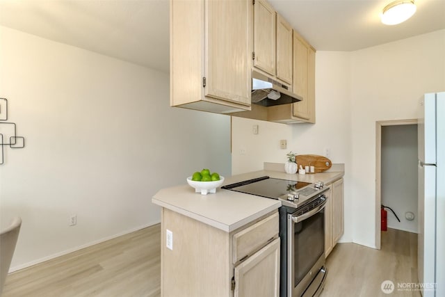 5129 Green Hills Ave NE Unit A, Tacoma, WA 98422 - kitchen featuring electric range, under cabinet range hood, light wood-style flooring, and freestanding refrigerator