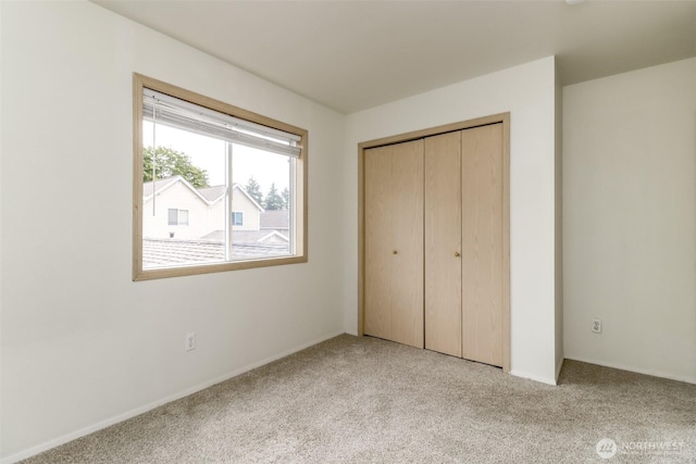 5129 Green Hills Ave NE Unit A, Tacoma, WA 98422 - unfurnished bedroom featuring light colored carpet, a closet, and baseboards