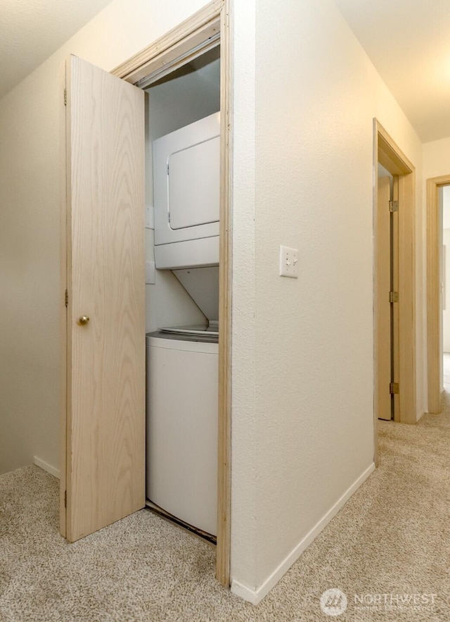 5129 Green Hills Ave NE Unit A, Tacoma, WA 98422 - washroom featuring estacked washer and dryer, carpet flooring, and baseboards