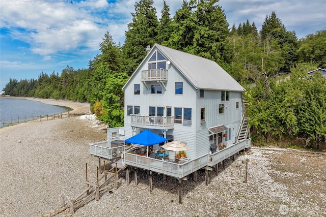17257 Olympic View Rd NW, Silverdale, WA 98383 - rear view of house with a balcony, stairs, a wooded view, and a deck with water view