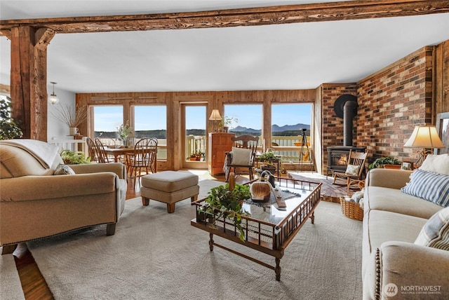 17257 Olympic View Rd NW, Silverdale, WA 98383 - living room with a wood stove, a mountain view, wood finished floors, and brick wall