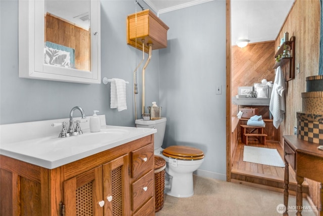 17257 Olympic View Rd NW, Silverdale, WA 98383 - bathroom with vanity, ornamental molding, and wood walls