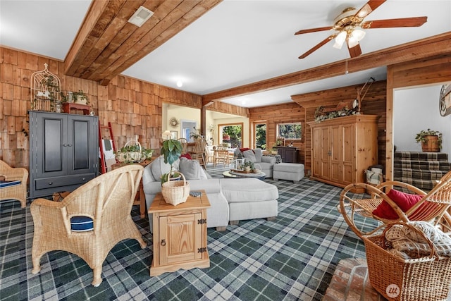 17257 Olympic View Rd NW, Silverdale, WA 98383 - living area featuring dark colored carpet, wood walls, a ceiling fan, and beamed ceiling