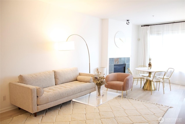 1900 Alaskan Way Unit 105, Seattle, WA 98101 - living area with a fireplace and wood finished floors