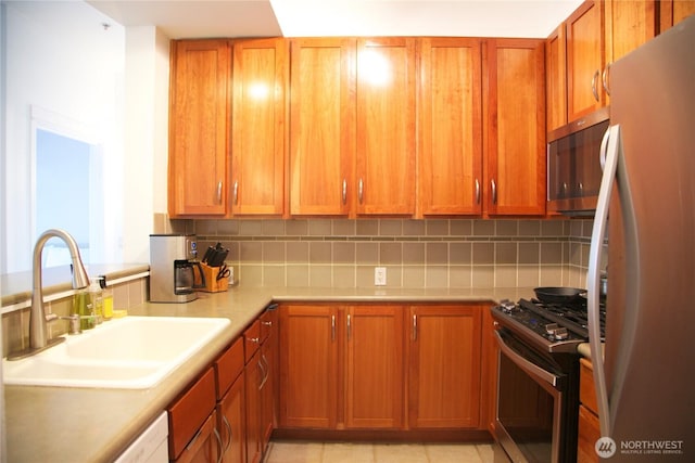 1900 Alaskan Way Unit 105, Seattle, WA 98101 - kitchen featuring appliances with stainless steel finishes, a sink, backsplash, and light countertops