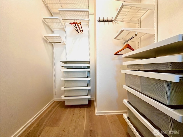 1900 Alaskan Way Unit 105, Seattle, WA 98101 - walk in closet featuring wood finished floors