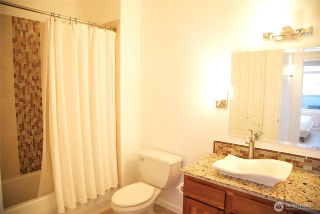 1900 Alaskan Way Unit 105, Seattle, WA 98101 - bathroom featuring vanity, toilet, decorative backsplash, and shower / bath combo with shower curtain