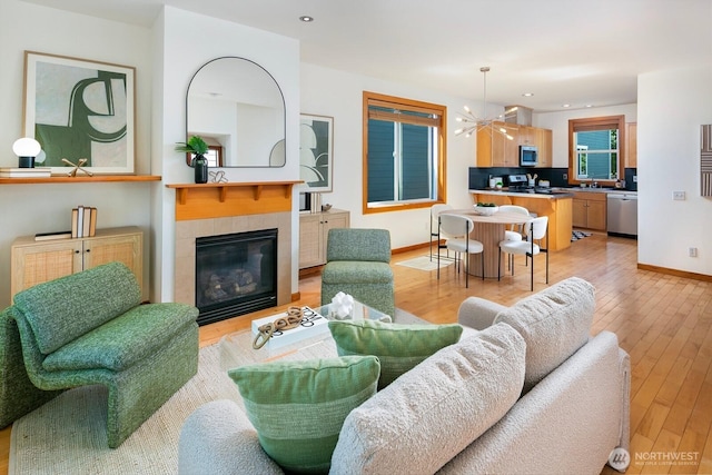 1414 25th Ave Unit B, Seattle, WA 98122 - living area with a fireplace, light wood-style flooring, a chandelier, and recessed lighting
