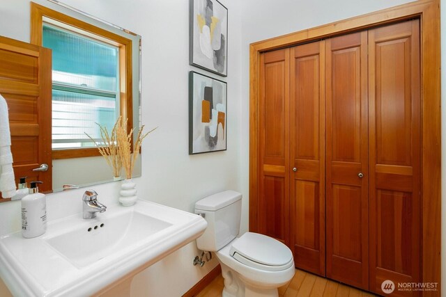 1414 25th Ave Unit B, Seattle, WA 98122 - half bathroom featuring a closet and wood finished floors