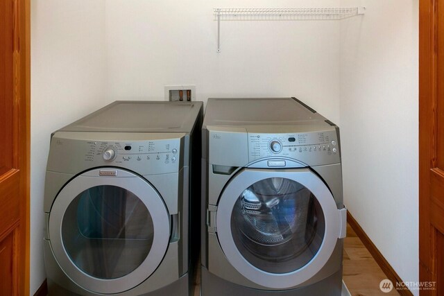 1414 25th Ave Unit B, Seattle, WA 98122 - washroom featuring washing machine and clothes dryer and wood finished floors