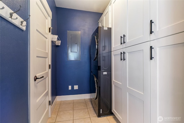 805 11th St, Bellingham, WA 98225 - washroom with estacked washer and dryer, cabinet space, light tile patterned flooring, baseboards, and electric panel