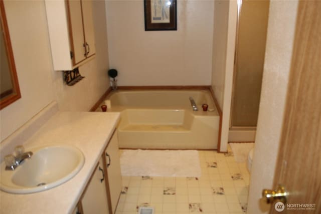 306 E 5th St, Lind, WA 99341 - full bathroom with vanity, a garden tub, a shower stall, and tile patterned floors