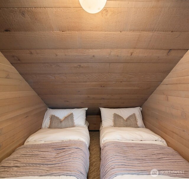 11901 Larson Rd, Anderson Island, WA 98303 - bedroom with wooden walls, wood ceiling, carpet flooring, and vaulted ceiling
