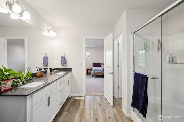 534 Gilbertson Ln SE, Olympia, WA 98501 - bathroom with wood finished floors, double vanity, ensuite bath, and plenty of natural light