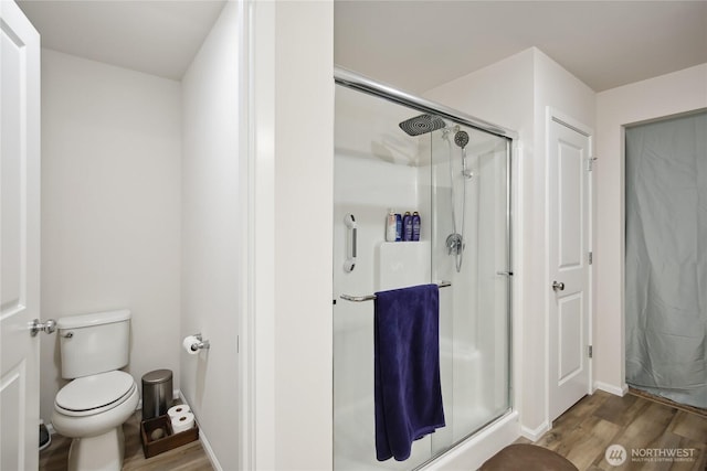 534 Gilbertson Ln SE, Olympia, WA 98501 - full bathroom featuring wood finished floors, a shower stall, toilet, and baseboards