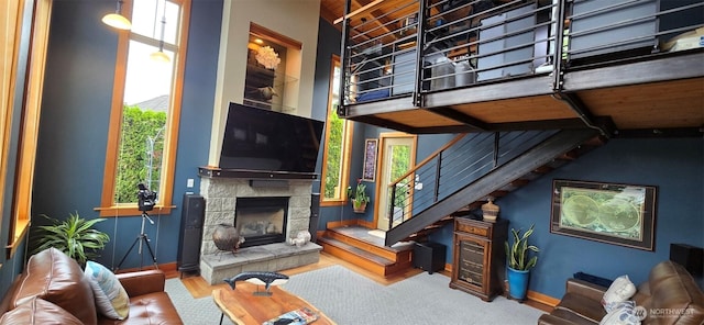 8145 Chehalis Rd, Blaine, WA 98230 - living room with a stone fireplace, stairs, baseboards, and wood finished floors