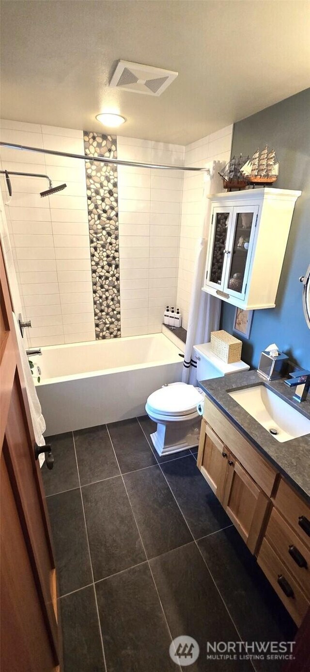 8145 Chehalis Rd, Blaine, WA 98230 - bathroom featuring tile patterned floors, vanity, washtub / shower combination, and toilet