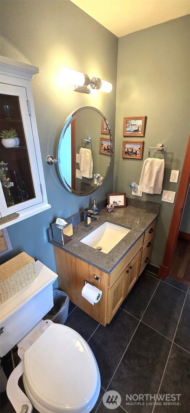 8145 Chehalis Rd, Blaine, WA 98230 - half bathroom featuring tile patterned floors, vanity, toilet, and baseboards