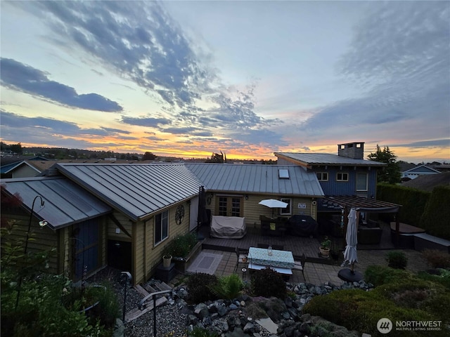 8145 Chehalis Rd, Blaine, WA 98230 - back of property featuring a standing seam roof, a deck, metal roof, outdoor lounge area, and a patio