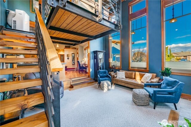 8145 Chehalis Rd, Blaine, WA 98230 - carpeted living room featuring beam ceiling and stairway