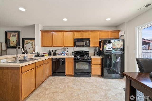 6600 Carolina St SE, Lacey, WA 98513 - kitchen with black appliances, a sink, a peninsula, light countertops, and recessed lighting