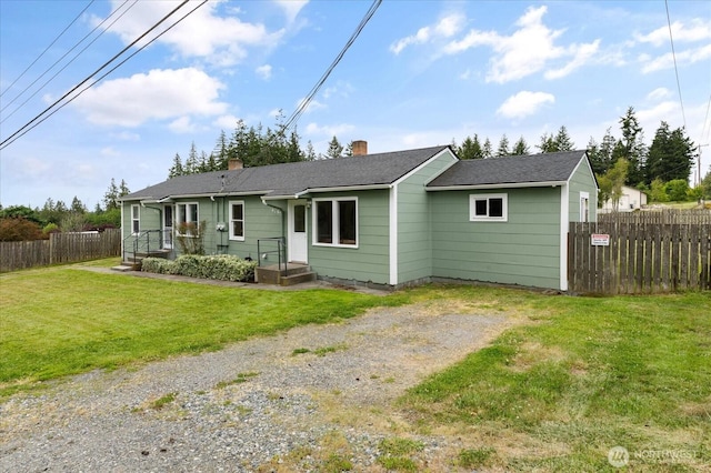 4191 N Imperial Ln, Oak Harbor, WA 98277 - back of house featuring a chimney, driveway, and a shingled roof