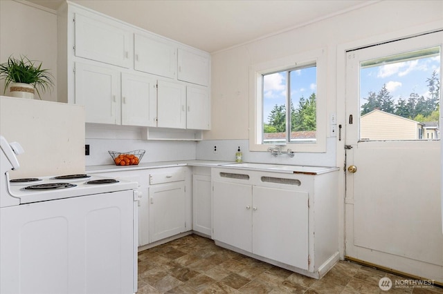 4191 N Imperial Ln, Oak Harbor, WA 98277 - kitchen featuring white range with electric stovetop, light countertops, white cabinetry, and a sink