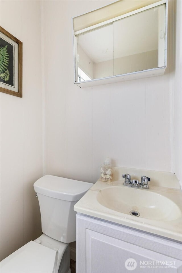 4191 N Imperial Ln, Oak Harbor, WA 98277 - half bathroom with vanity, toilet, and a decorative wall