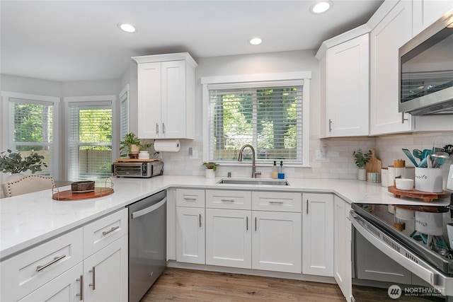 8367 Dolphin Way, Maple Falls, WA 98266 - kitchen featuring appliances with stainless steel finishes, a sink, plenty of natural light, white cabinets, and recessed lighting