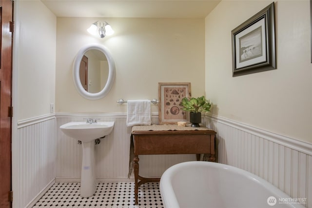 144 Sand Dune Ave SW, Ocean Shores, WA 98569 - full bath with a freestanding tub and a wainscoted wall