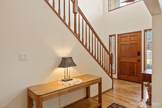 14406 144th St E, Orting, WA 98360 - foyer featuring light wood finished floors, a towering ceiling, and stairway