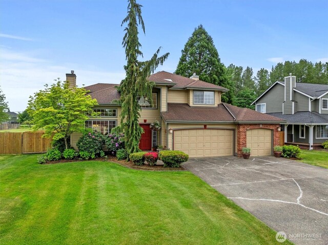 14406 144th St E, Orting, WA 98360 - view of front of house with driveway, a garage, and a chimney