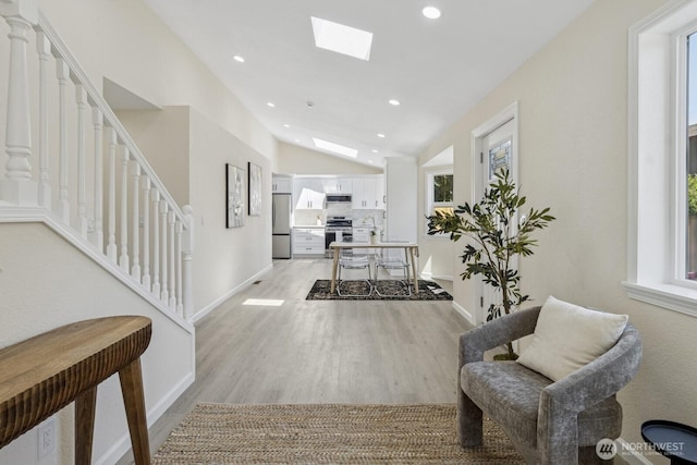 16828 Ambaum Blvd S, Burien, WA 98148 - hallway featuring light wood-style flooring, lofted ceiling, recessed lighting, a skylight, and stairway