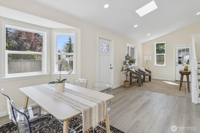 16828 Ambaum Blvd S, Burien, WA 98148 - dining room featuring a skylight, light wood-type flooring, lofted ceiling, and recessed lighting