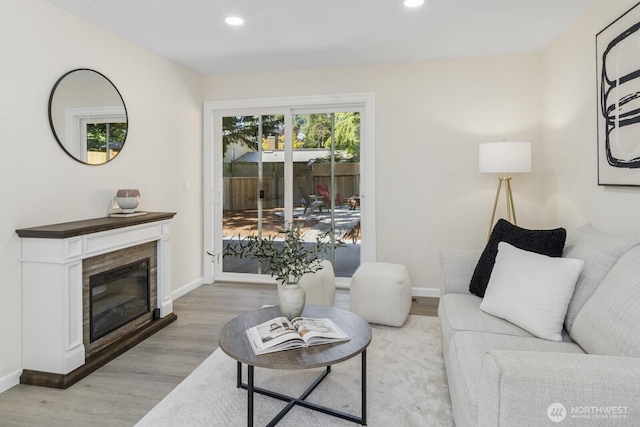 16828 Ambaum Blvd S, Burien, WA 98148 - living room featuring light wood-type flooring, recessed lighting, and a glass covered fireplace