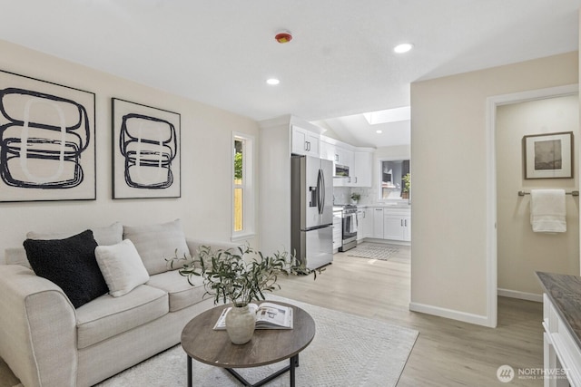 16828 Ambaum Blvd S, Burien, WA 98148 - living area featuring light wood finished floors, healthy amount of natural light, a skylight, and recessed lighting