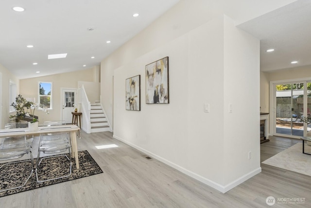 16828 Ambaum Blvd S, Burien, WA 98148 - home office featuring light wood-style floors, plenty of natural light, recessed lighting, a glass covered fireplace, and lofted ceiling