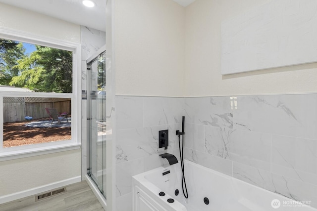 16828 Ambaum Blvd S, Burien, WA 98148 - bathroom featuring a tub with jets, wood finished floors, and a shower stall